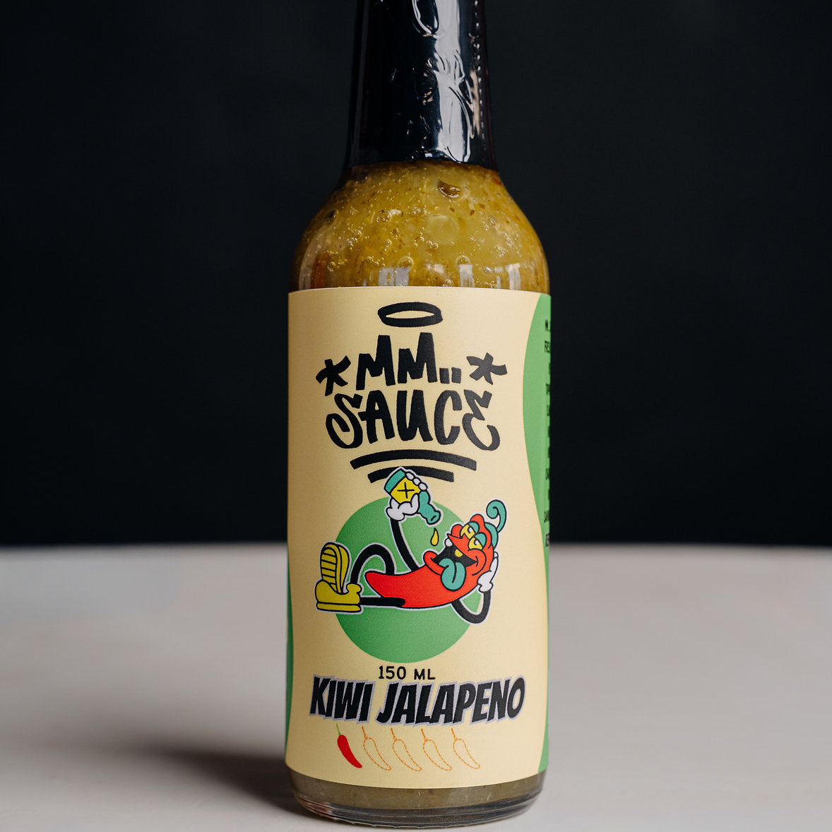 A bottle of Kiwi Jalapeno hot sauce by MM...SAUCE